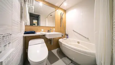 a bathroom with a toilet and a sink and a tub at DEL style Ikebukuro Higashiguchi by Daiwa Roynet Hotel in Tokyo