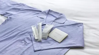 a blue shirt with a book on a bed at Toyoko Inn Tokyo Akabane-eki Higashi-guchi in Tokyo