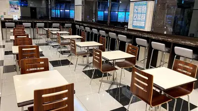 a row of tables and chairs in a cafeteria at Toyoko Inn Tokyo Akabane-eki Higashi-guchi in Tokyo