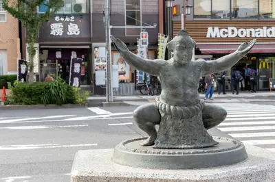 a statue of a woman sitting on the side of a street at Pearl Hotel Ryogoku in Tokyo