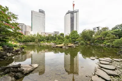 a pond in a city with tall buildings at Pearl Hotel Ryogoku in Tokyo