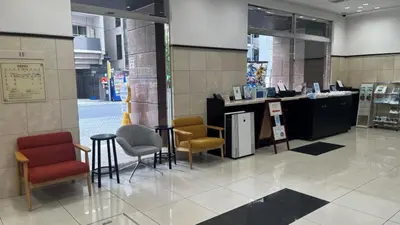 a lobby with chairs and a counter in a store at Toyoko Inn Tokyo Shinagawa Konan-guchi Tennozu Isle in Tokyo