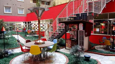 a patio with a table and chairs in front of a building at Toyoko Inn Tokyo Shinagawa Konan-guchi Tennozu Isle in Tokyo