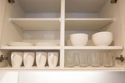 a white cabinet filled with dishes and glasses at HIZ HOTEL - Vacation STAY 18549v in Tokyo