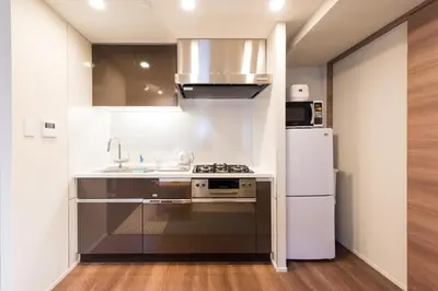 a kitchen with a stove and a refrigerator at HIZ HOTEL - Vacation STAY 18549v in Tokyo