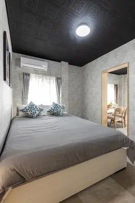 a bedroom with a large bed and a table at Urban Stay Oshiage in Tokyo