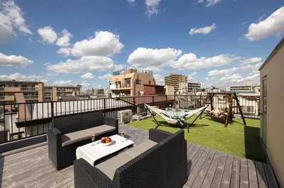 a balcony with a patio furniture and a playground at Urban Stay Oshiage in Tokyo