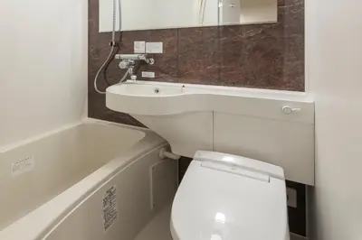 a bathroom with a white toilet and a sink at Asta Hotel in Tokyo