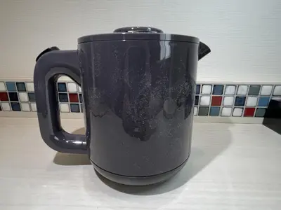 a black cup sitting on a kitchen counter at Asta Hotel in Tokyo