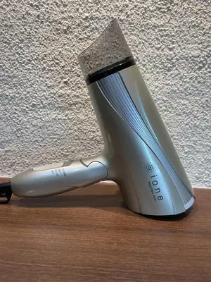 a hair dryer sitting on top of a wooden table at Asta Hotel in Tokyo