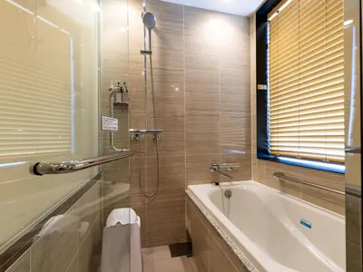 a bathroom with a bath tub and a shower at APA Hotel Keikyukamata Ekimae in Tokyo