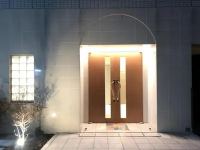 a brown door with lights on a building at Otsuka No 4 Mansion in Tokyo