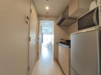 a kitchen with a refrigerator and a hallway at Otsuka No 4 Mansion in Tokyo