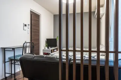 a bedroom with a bed and a desk with a computer at T-BASE - Vacation STAY 21950v in Tokyo