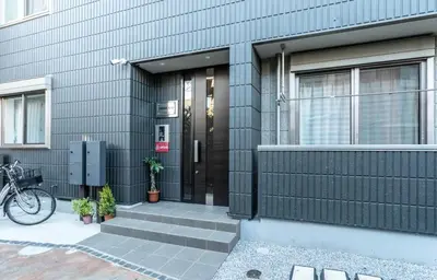 a house with a black door and a bike parked outside at T-BASE - Vacation STAY 21950v in Tokyo