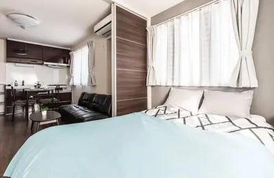 a bedroom with a bed and a dining room at T-BASE - Vacation STAY 21952v in Tokyo