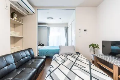 a living room with a couch and a bed at T-BASE - Vacation STAY 21952v in Tokyo