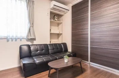 a living room with a leather couch and a table at T-BASE - Vacation STAY 21952v in Tokyo