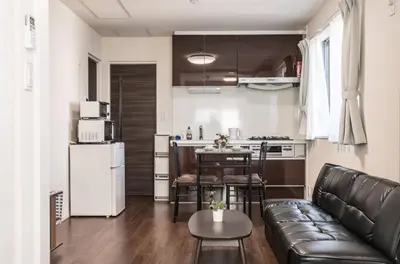 a living room with a couch and a kitchen at T-BASE - Vacation STAY 21952v in Tokyo