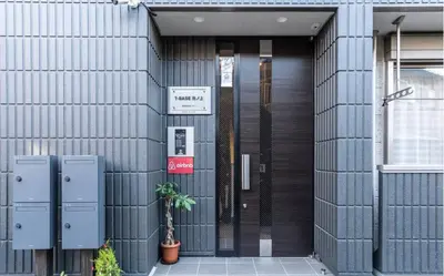a facade of a building with a revolving door at T-BASE - Vacation STAY 21952v in Tokyo