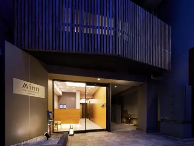 an entrance to an office building at night at Minn Asakusa in Tokyo