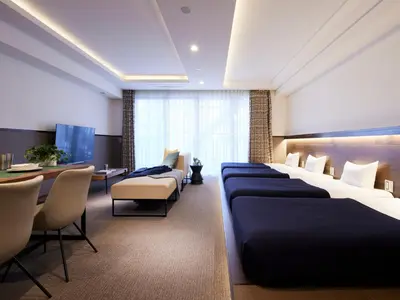 a hotel room with beds and a table and chairs at Minn Asakusa in Tokyo