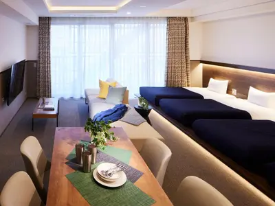 a hotel room with a large bed and a table at Minn Asakusa in Tokyo