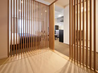 a room with a partition with a bed in the background at Minn Asakusa in Tokyo