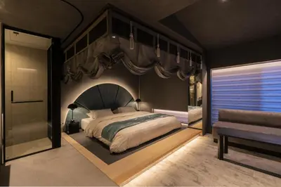 a bedroom with a large bed and a shower at moire HOTEL YOSHIWARA in Tokyo