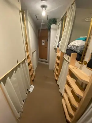 a hallway of a dorm room with bunk beds at 54Journey \u6771\u4eac\u5927\u624b\u753a\u30db\u30b9\u30c6\u30eb in Tokyo
