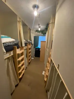 a hallway of a dorm room with bunk beds at 54Journey \u6771\u4eac\u5927\u624b\u753a\u30db\u30b9\u30c6\u30eb in Tokyo