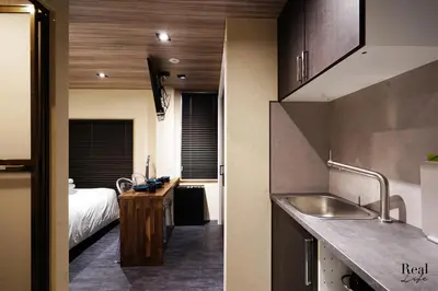 a kitchen with a sink and a bed in a room at Real Life SANGENJAYA in Tokyo