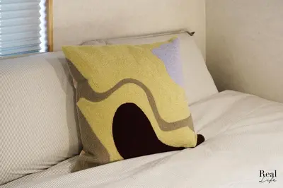 a pillow sitting on top of a bed at Real Life SANGENJAYA in Tokyo