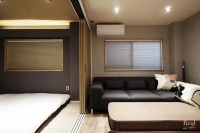 a living room with a couch and a bed at Real Life SANGENJAYA in Tokyo