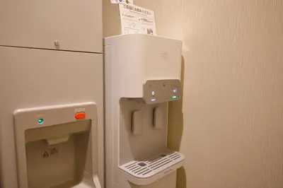 a white refrigerator with a pay phone next to it at Odakyu Hotel Century Southern Tower in Tokyo