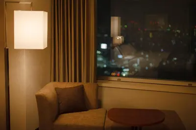 a hotel room with a chair and a window at Odakyu Hotel Century Southern Tower in Tokyo