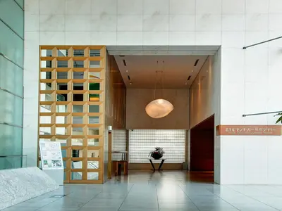 a lobby of a building with a wooden door at Odakyu Hotel Century Southern Tower in Tokyo