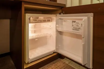 an empty refrigerator with its door open in a kitchen at Odakyu Hotel Century Southern Tower in Tokyo
