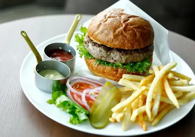 a plate of food with a hamburger and french fries at Odakyu Hotel Century Southern Tower in Tokyo