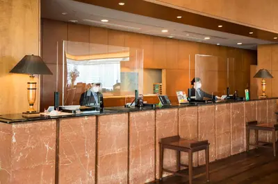 two people sitting at a bar in a hotel lobby at Odakyu Hotel Century Southern Tower in Tokyo