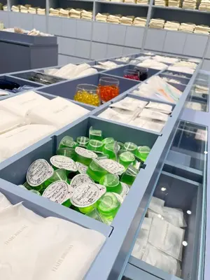 a shelf filled with green plastic containers in a store at Oriental Hotel Tokyo Bay in Urayasu