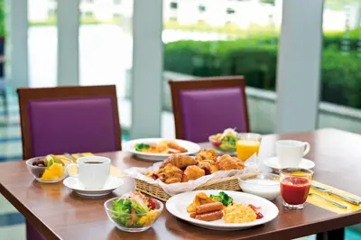 a wooden table with plates of food and drinks at Tokyo Dome Hotel in Tokyo