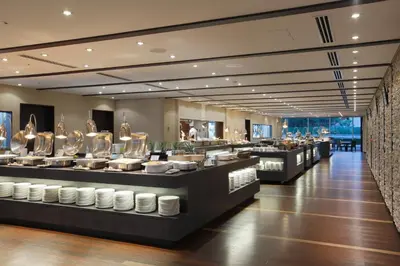 a restaurant with a buffet line with dishes at Tokyo Dome Hotel in Tokyo
