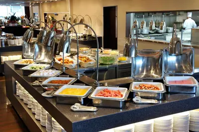 a buffet line with dishes of food in a restaurant at Tokyo Dome Hotel in Tokyo