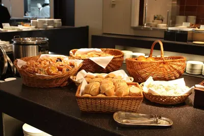 a table with baskets of bread and pastries on it at Tokyo Dome Hotel in Tokyo