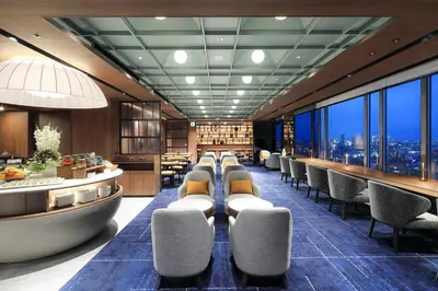 a restaurant with chairs and a bar with a view at Tokyo Dome Hotel in Tokyo