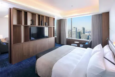 a hotel room with a large bed and a large window at Tokyo Dome Hotel in Tokyo