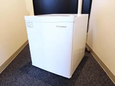 a white refrigerator in the corner of a room at HOTEL LiVEMAX Akasaka GRANDE in Tokyo