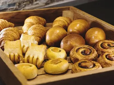 a wooden box filled with lots of different types of pastries at R&B HOTEL UENO HIROKOJI - Vacation STAY 13873v in Tokyo