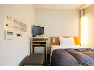 a hotel room with two beds and a television at R&B HOTEL HIGASHI NIHONBASHI - Vacation STAY 14016v in Tokyo
